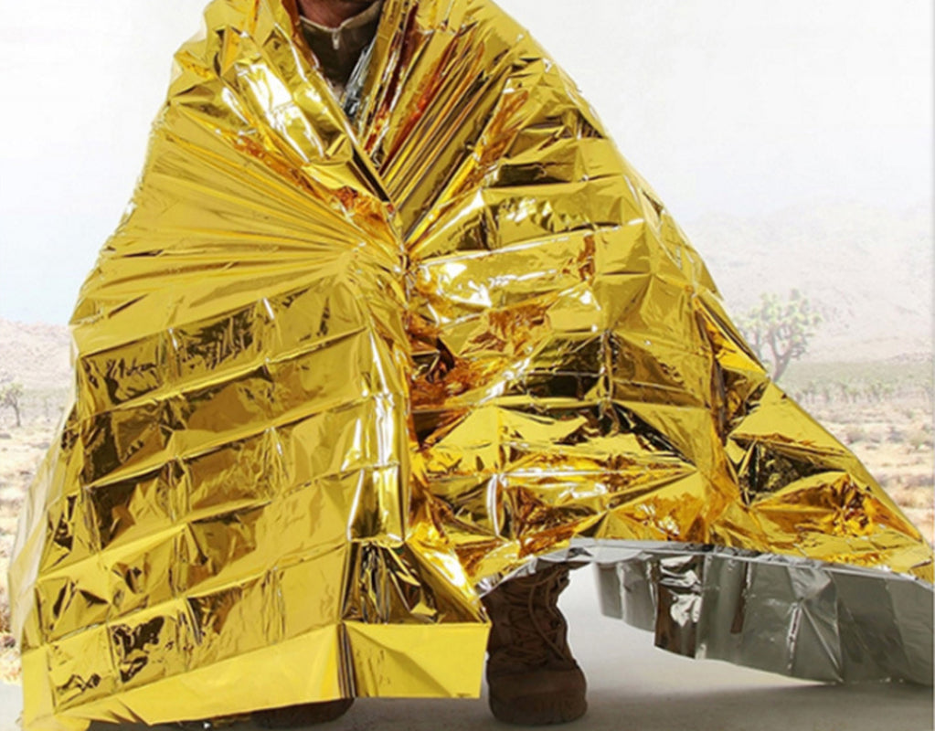 Human Body Hypothermia Lifesaving Emergency Blanket in Outdoor Field